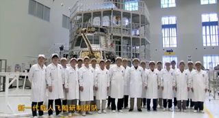 China Academy of Space Technology team members in front of the new crewed spacecraft.