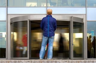 Man standing in front of revolving door