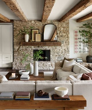 Living room with exposed brick wall, neutral furniture and accessories
