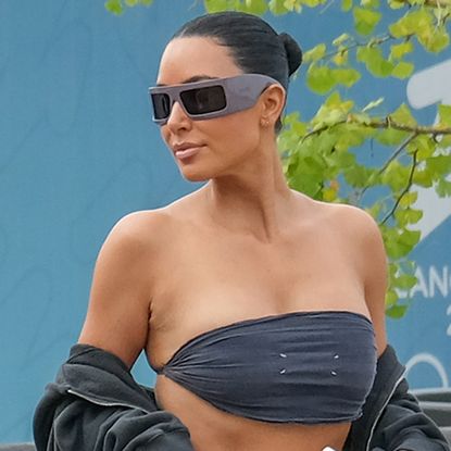 Kim Kardashian arrives at the Besos wedding in Venice wearing a bandeau top from Balenciaga.