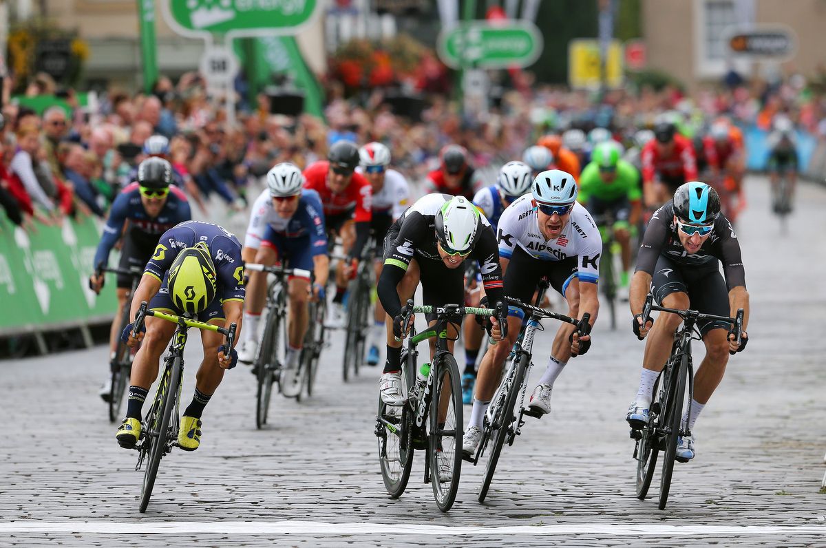 Caleb Ewan wins with a bike throw