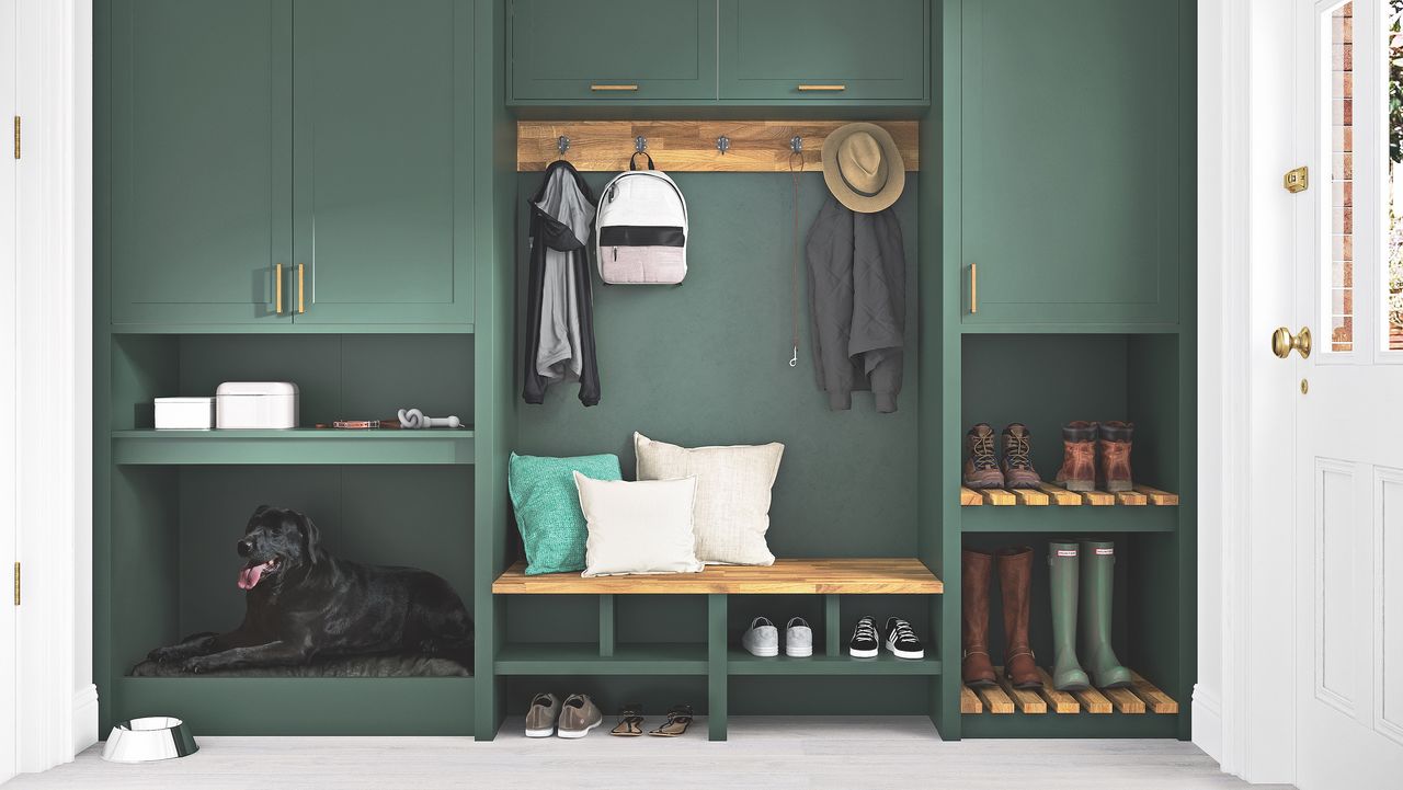 small boot room with green cabinets and bench