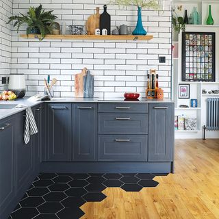 black kitchen with white tiles and wood floor