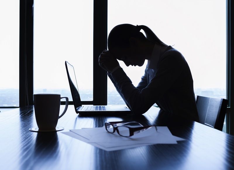 a woman looking sad at computer