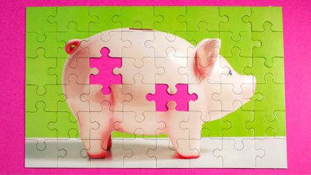Jigsaw puzzle of piggy bank on pink surface