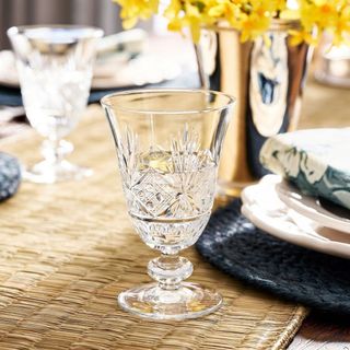 Antique Cut Glass Goblets on a rattan placemat. 