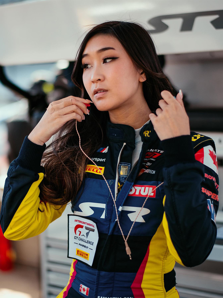 Pro race car driver Samantha Tan wearing a racing jumpsuit.