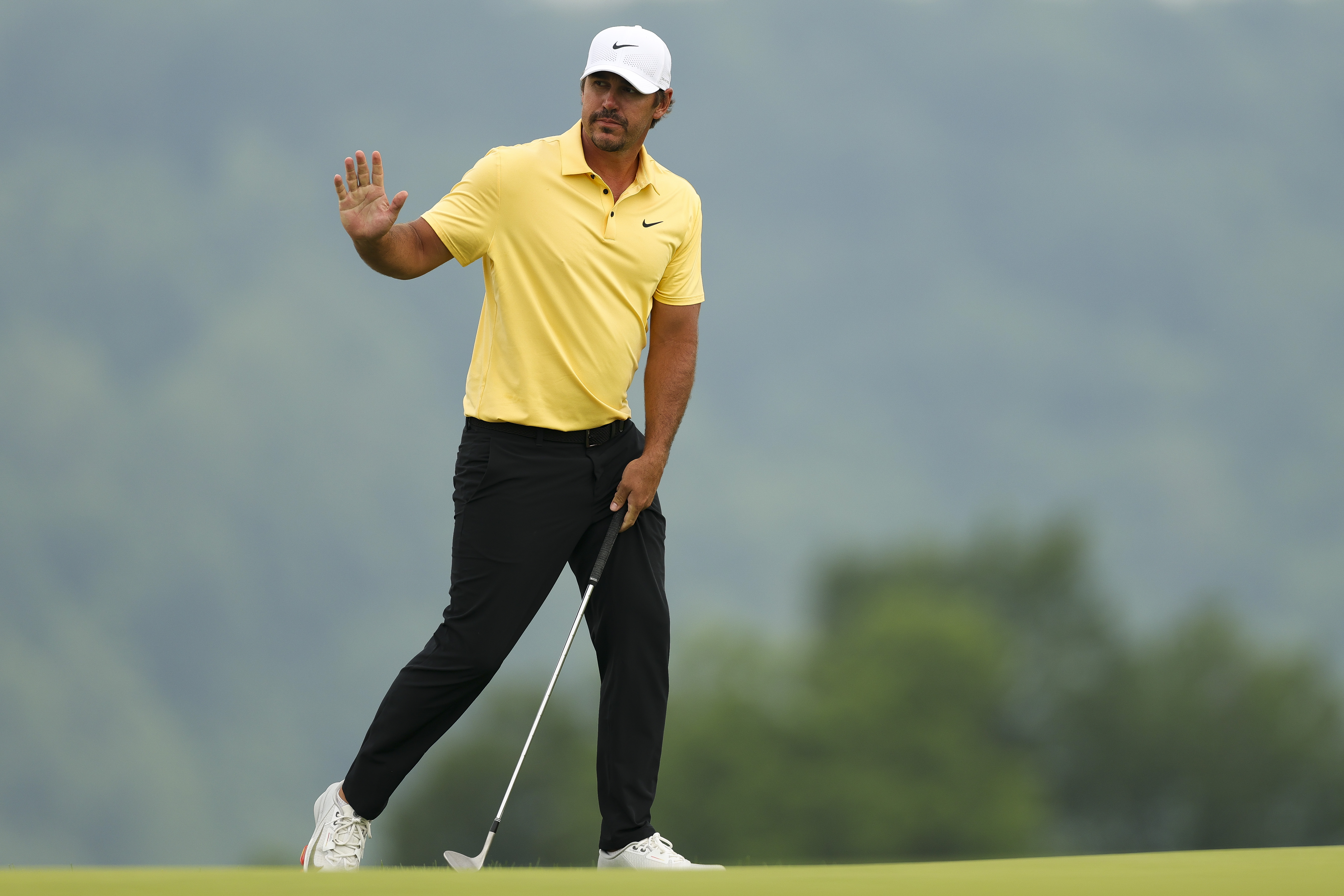 Brooks Koepka waves to the crowd
