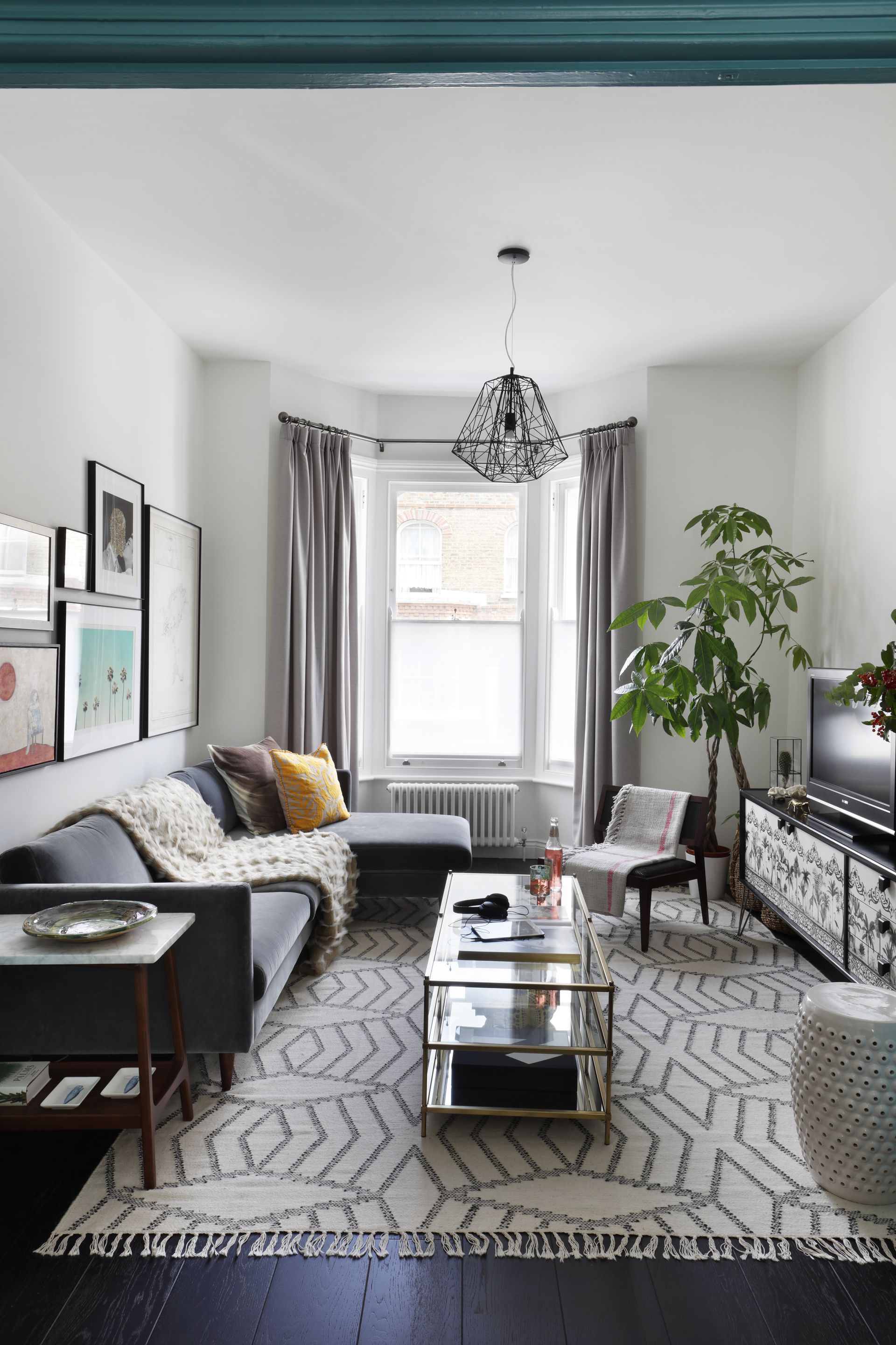 monochrome living room showing black and white fixture and fittings and a decorate TV panel