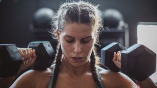 Woman holding dumbbells