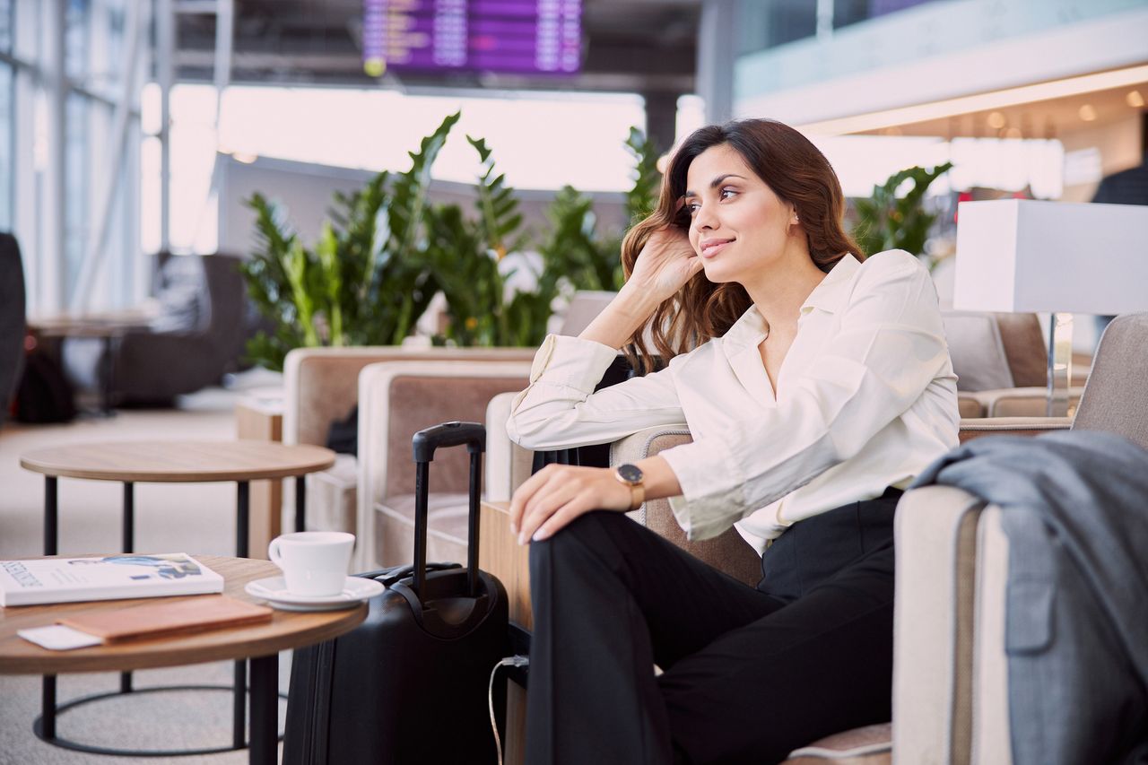 Woman relaxing before flight with airport lounge access