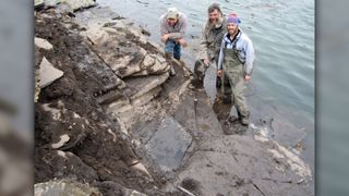 From left, Gene Primaky, Jim Baichtal and Patrick Druckenmiller stand in rising waters after the thalattosaur fossil was removed. Minutes later, the tide submerged the excavation site.