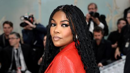 Gabrielle Union in a red blazer wearing her hair in goddess braids