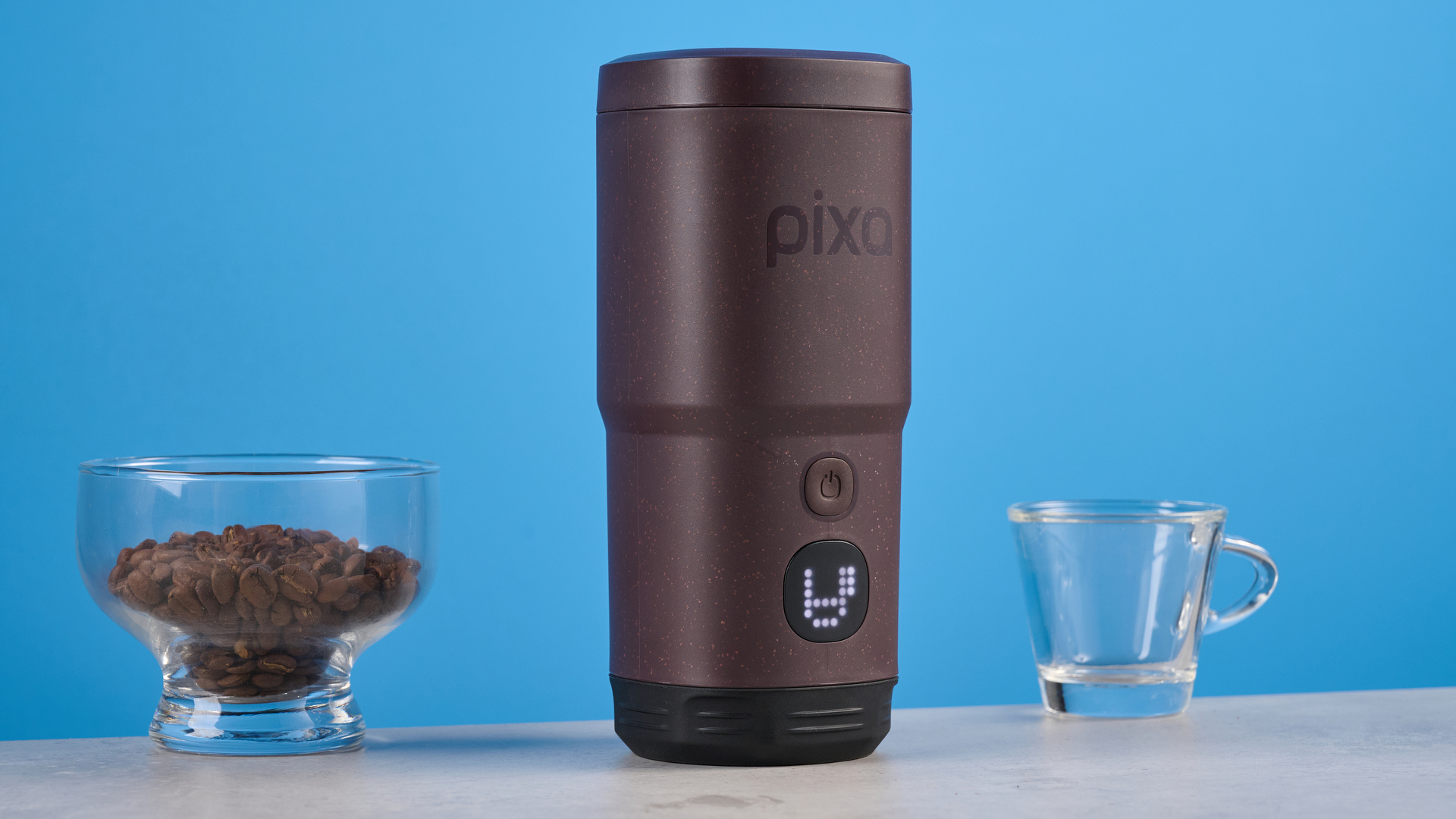 the wacaco pixapresso portable self-heating espresso maker in dark purple color showing usability with nespresso pods and ground coffee, ideal for vacations and camping