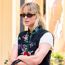 Jennifer Lawrence wore an embroidered vest with baggy jeans and Manolo Blahnik sandals