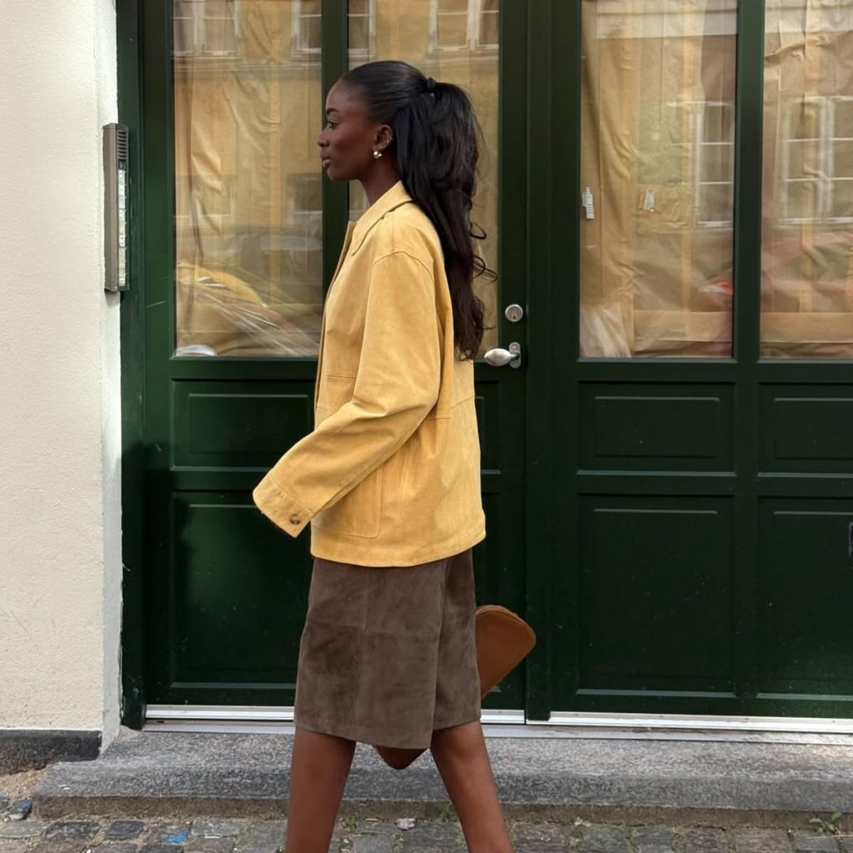 woman wearing yellow suede jacket