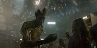 Groot (Vin Diesel) giving a flower to a young girl in Guardians of the Galaxy