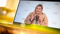 LONDON, UNITED KINGDOM - MARCH 26: In this photo illustration, IOC President Kirsty Coventry is seen on a computer screen as she speaks at a live-streamed press briefing from Lausanne, Switzerland about the newly announced ban on transgender athletes in women's events on March 26, 2026 as viewed in London, United Kingdom. Earlier today, the IOC issued its policy on the "Protection of the Female (Women's) Category in Olympic Sport and Guiding Considerations for International Federations and Sports Governing Bodies." The policy, which will be in effect from the Los Angeles 2028 Olympics, eligibility for women's events will require a one-time gene test. (Photo by Leon Neal/Getty Images)