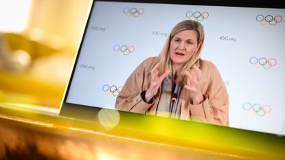 LONDON, UNITED KINGDOM - MARCH 26: In this photo illustration, IOC President Kirsty Coventry is seen on a computer screen as she speaks at a live-streamed press briefing from Lausanne, Switzerland about the newly announced ban on transgender athletes in women's events on March 26, 2026 as viewed in London, United Kingdom. Earlier today, the IOC issued its policy on the "Protection of the Female (Women's) Category in Olympic Sport and Guiding Considerations for International Federations and Sports Governing Bodies." The policy, which will be in effect from the Los Angeles 2028 Olympics, eligibility for women's events will require a one-time gene test. (Photo by Leon Neal/Getty Images)