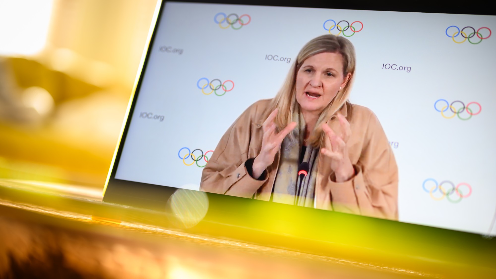 LONDON, UNITED KINGDOM - MARCH 26: In this photo illustration, IOC President Kirsty Coventry is seen on a computer screen as she speaks at a live-streamed press briefing from Lausanne, Switzerland about the newly announced ban on transgender athletes in women's events on March 26, 2026 as viewed in London, United Kingdom. Earlier today, the IOC issued its policy on the "Protection of the Female (Women's) Category in Olympic Sport and Guiding Considerations for International Federations and Sports Governing Bodies." The policy, which will be in effect from the Los Angeles 2028 Olympics, eligibility for women's events will require a one-time gene test. (Photo by Leon Neal/Getty Images)