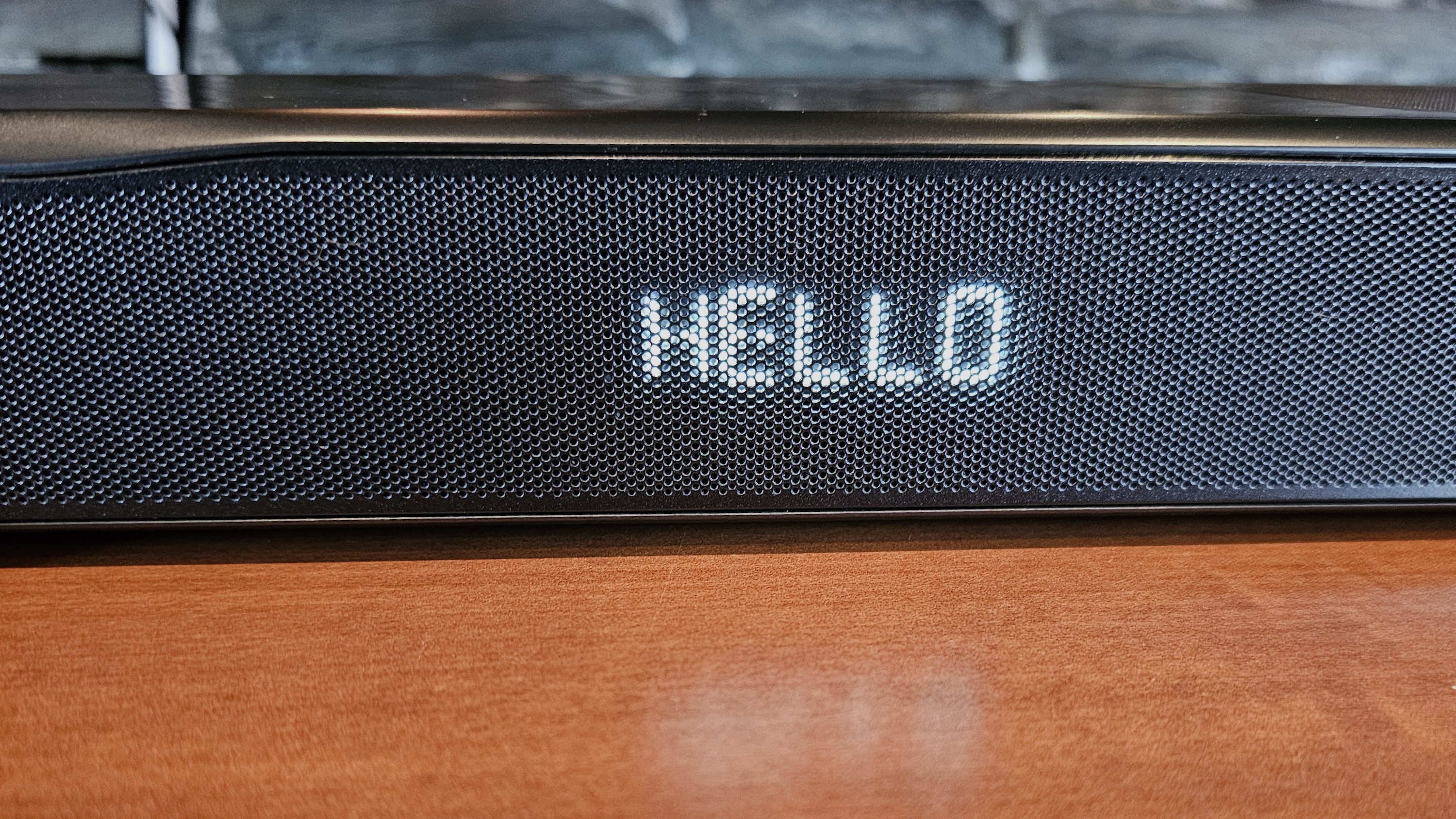 JBL Bar 1000MK2 on TV stand closeup of alphanumeric LED display