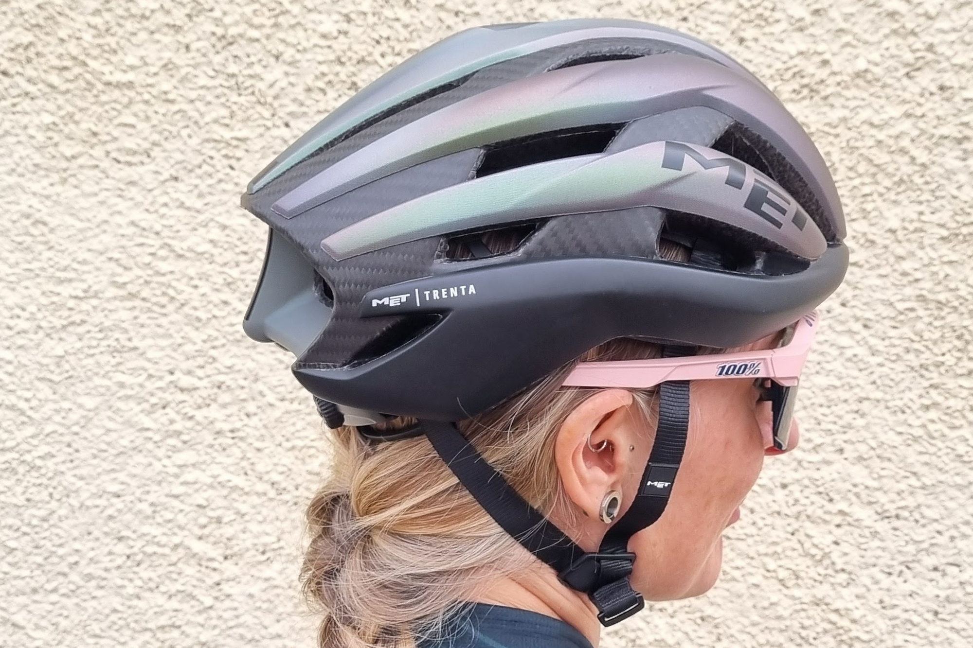 Cyclist wearing Met Trenta 3k carbon road helmet showing back and side