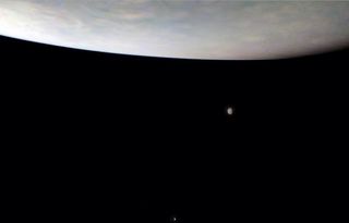 NASA's Juno probe captured this image of Jupiter's atmosphere and the moons Io (above) and Callisto (below) during a close flyby on Nov. 29, 2021.