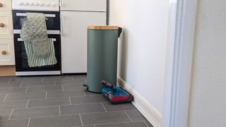 The Sumbarine head attachment next to a green bin, fridge and oven with bee oven gloves on it