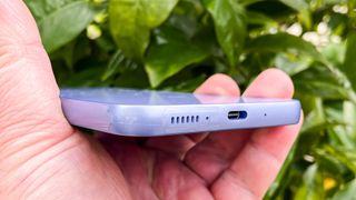 a purple Samsung Galaxy A54 seen seen from the bottom edge
