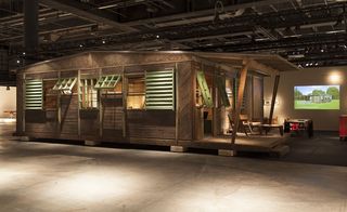 A display of a building in a museum. Jean Prouvé and Pierre Jeanneret's restored F 8x8 BCC House from 1942.