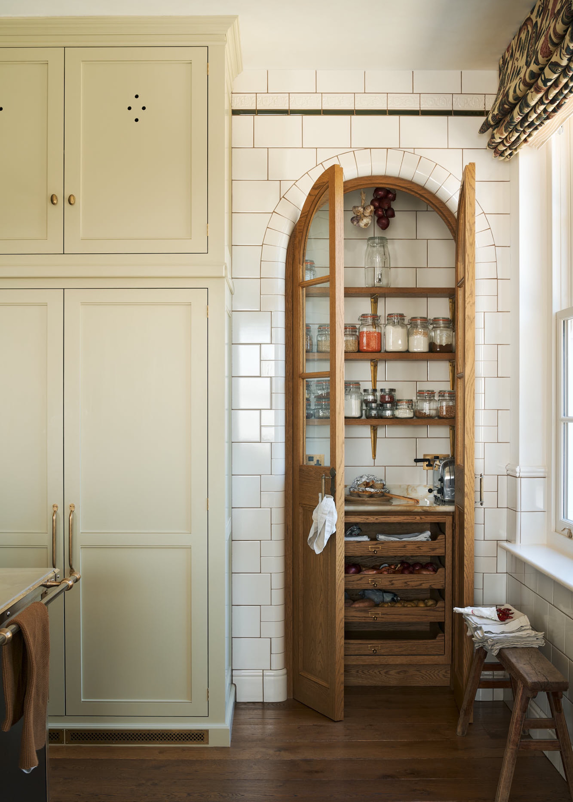kitchen storage with custom built arched pantry by deVOL