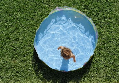 child in a paddling pool