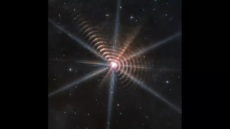 This image of strange concentric shells surrounding the distant star WR 140 was taken by the James Webb Space Telescope.