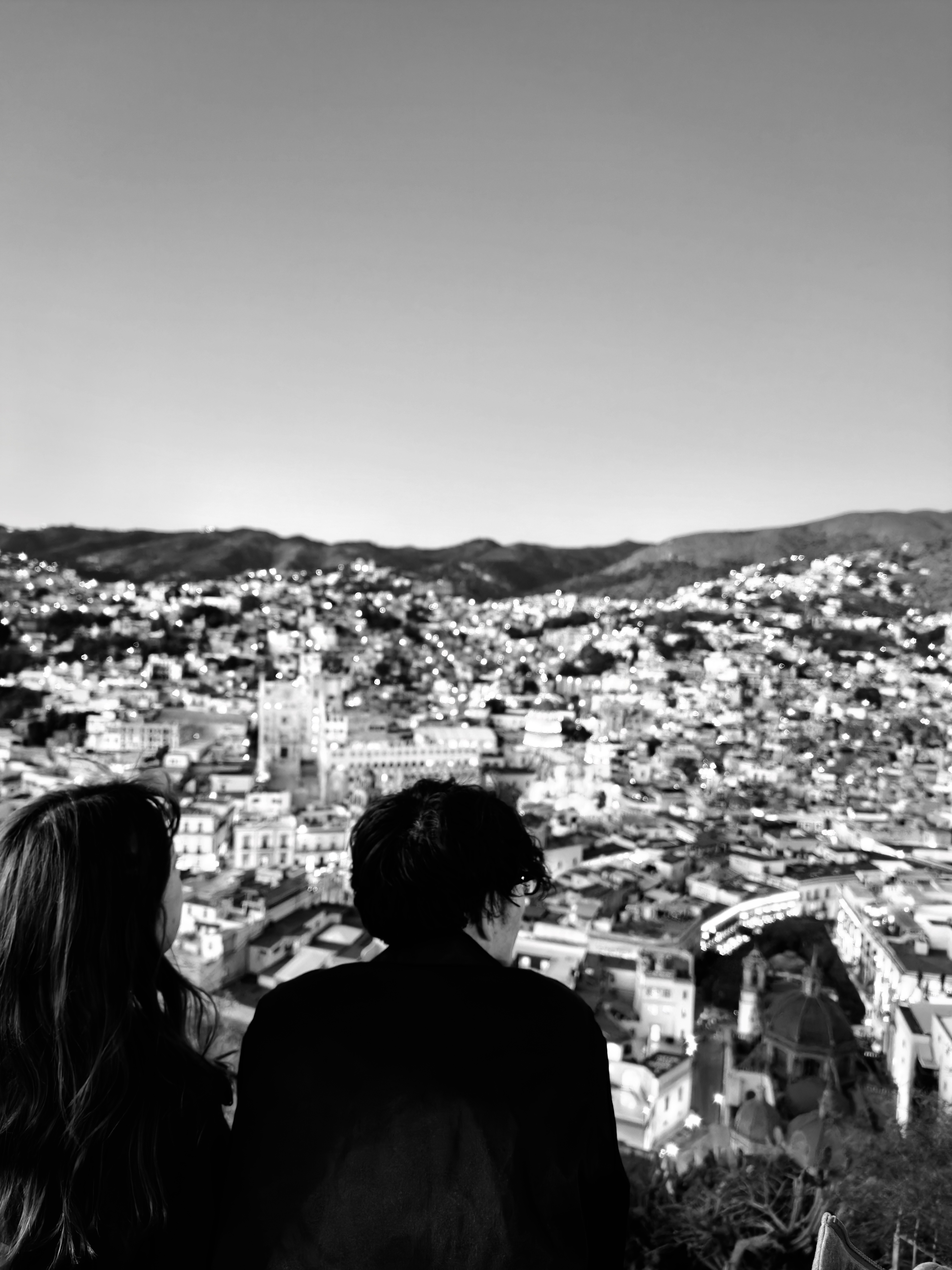 A couple gazing out over a Mexican city