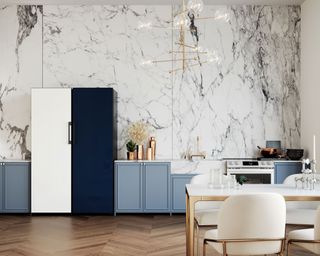 a samsung navy and white fridge freezer in a kitchen with marble effect wallpaper and brass lighting - samsung
