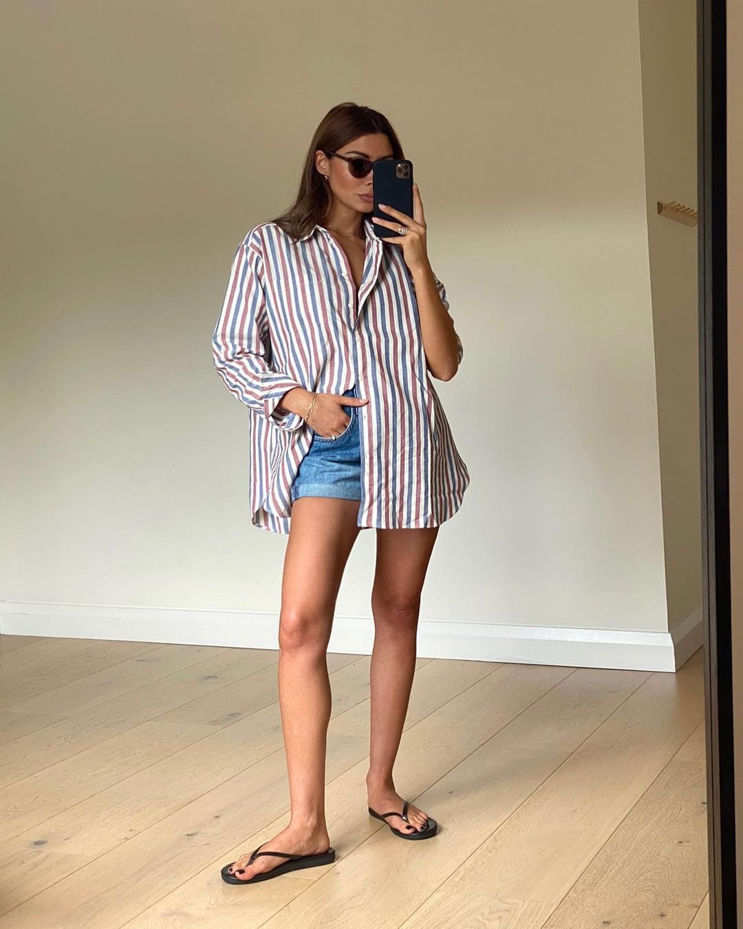 @smythsisters wearing an oversized shirt with shorts