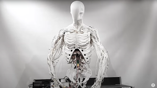 Screenshot from a video showing a robotic torso springing to life. The torso and the background are white.