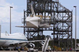 NASA's Shuttle Carrier Aircraft, or SCA, rolls beneath space shuttle Endeavour, suspended in the mate-demate device at the Shuttle Landing Facility at NASA's Kennedy Space Center in Florida on Sept. 14, 2012.