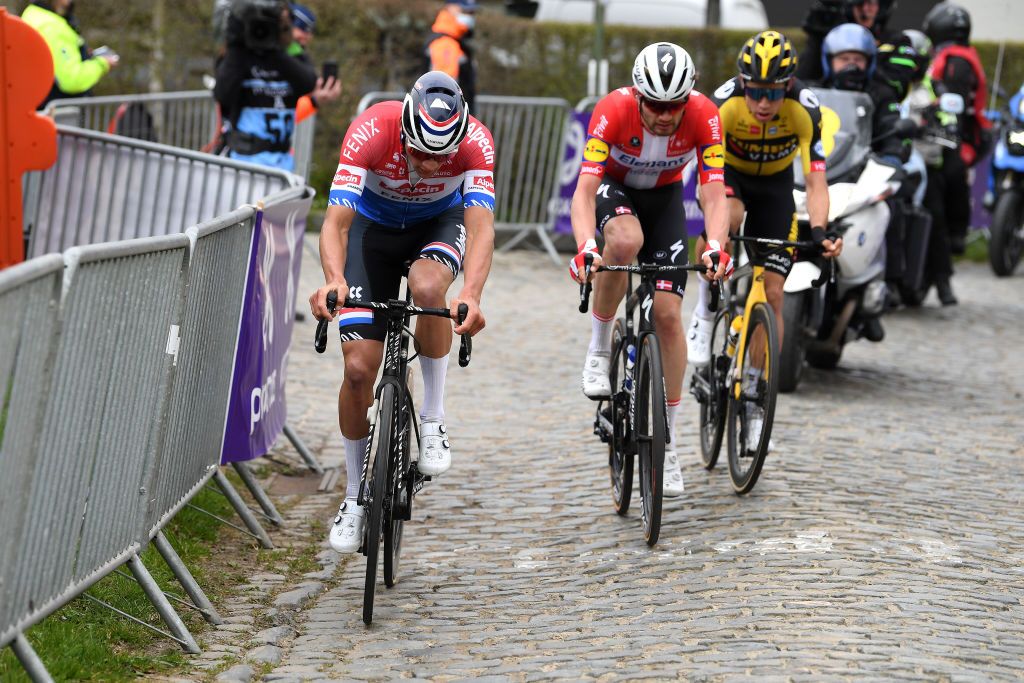 OUDENAARDE BELGIUM APRIL 04 Mathieu Van Der Poel of Netherlands and Team AlpecinFenix Kasper Asgreen of Denmark and Team Deceuninck QuickStep Wout Van Aert of Belgium and Team Jumbo Visma during the 105th Ronde van Vlaanderen Tour of Flanders 2021 Mens Elite a 2515km race from Antwerp to Oudenaarde Oude Kwaremont Cobblestones Sector RVV21 rondevanvlaanderen tourofflanders on April 04 2021 in Oudenaarde Belgium Photo by Tim de WaeleGetty Images