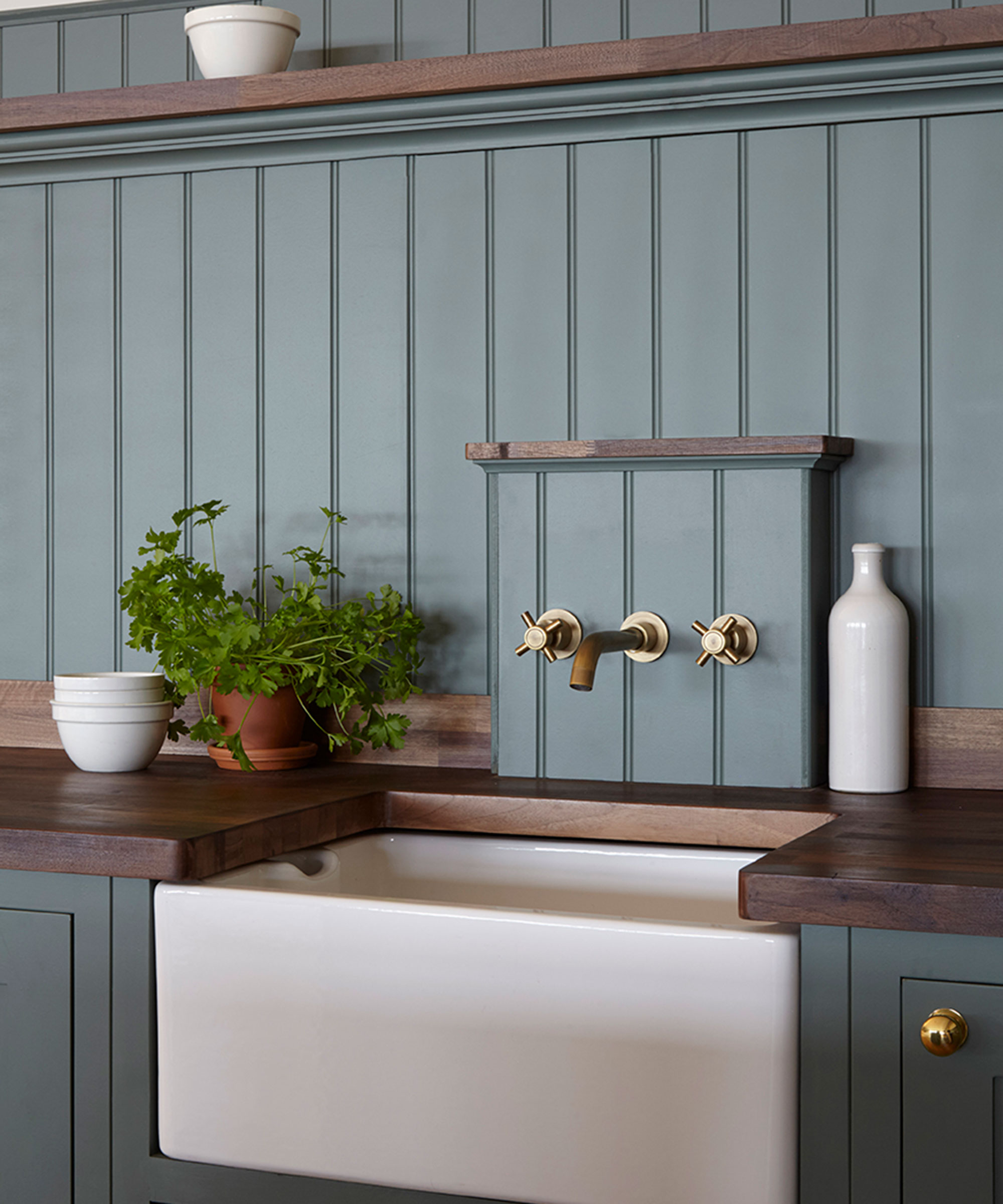 white Butler sink in blue Shaker kitchen