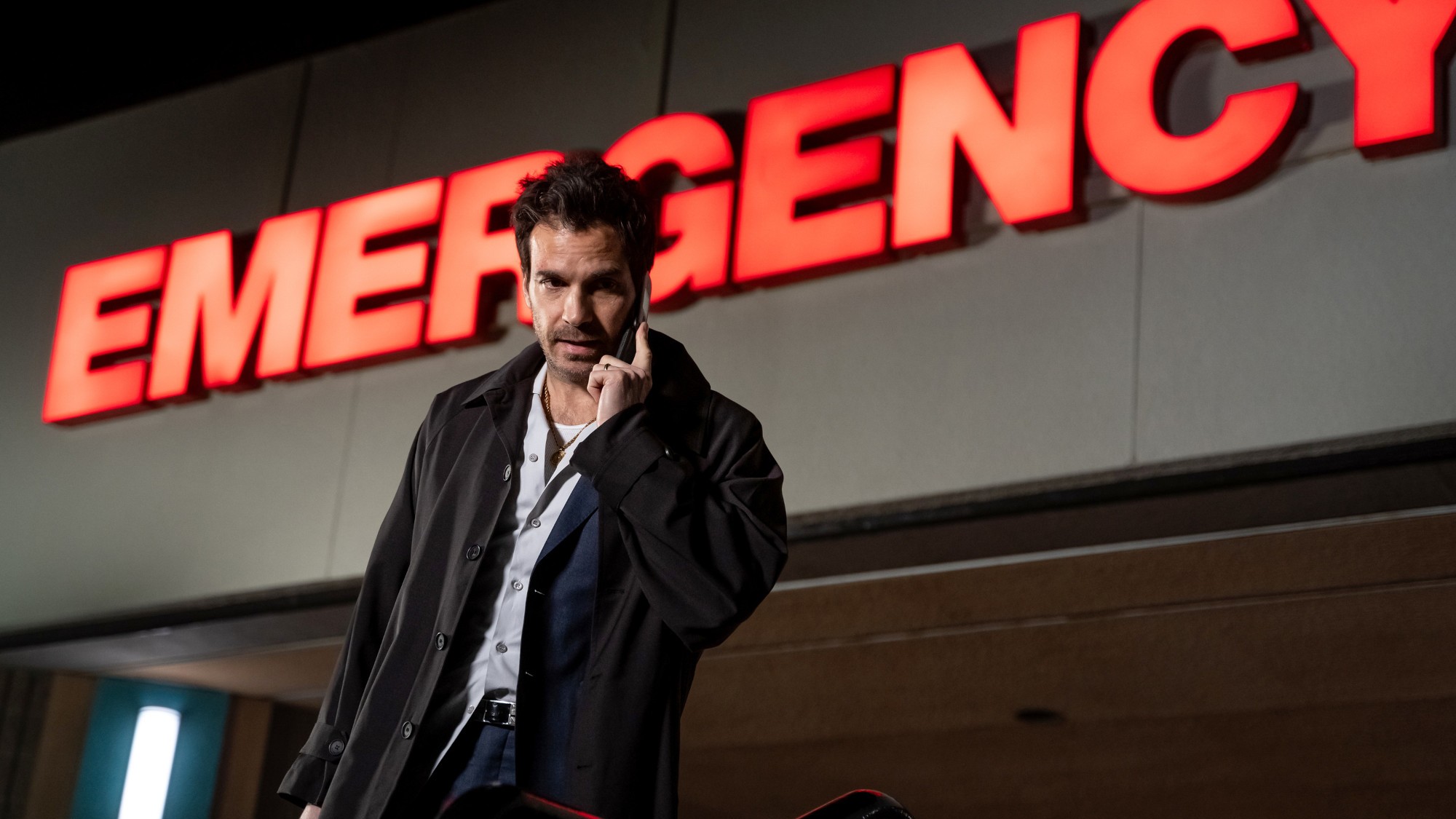 Santiago Cabrera on the phone outside a hospital emergency room in The Cleaning Lady