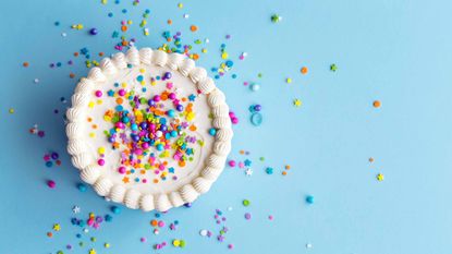 white birthday cake with rainbow confetti