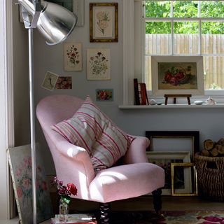 white room with pink armchair and walled picture