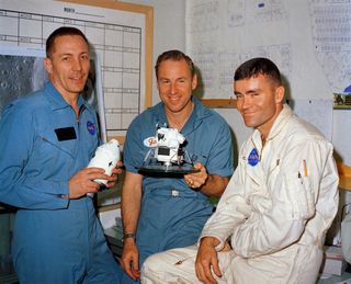 Apollo 13 astronauts Jack Swigert, Jim Lovell and Fred Haise seen with a model of their capsule on April 10, 1970, the day before they launched.