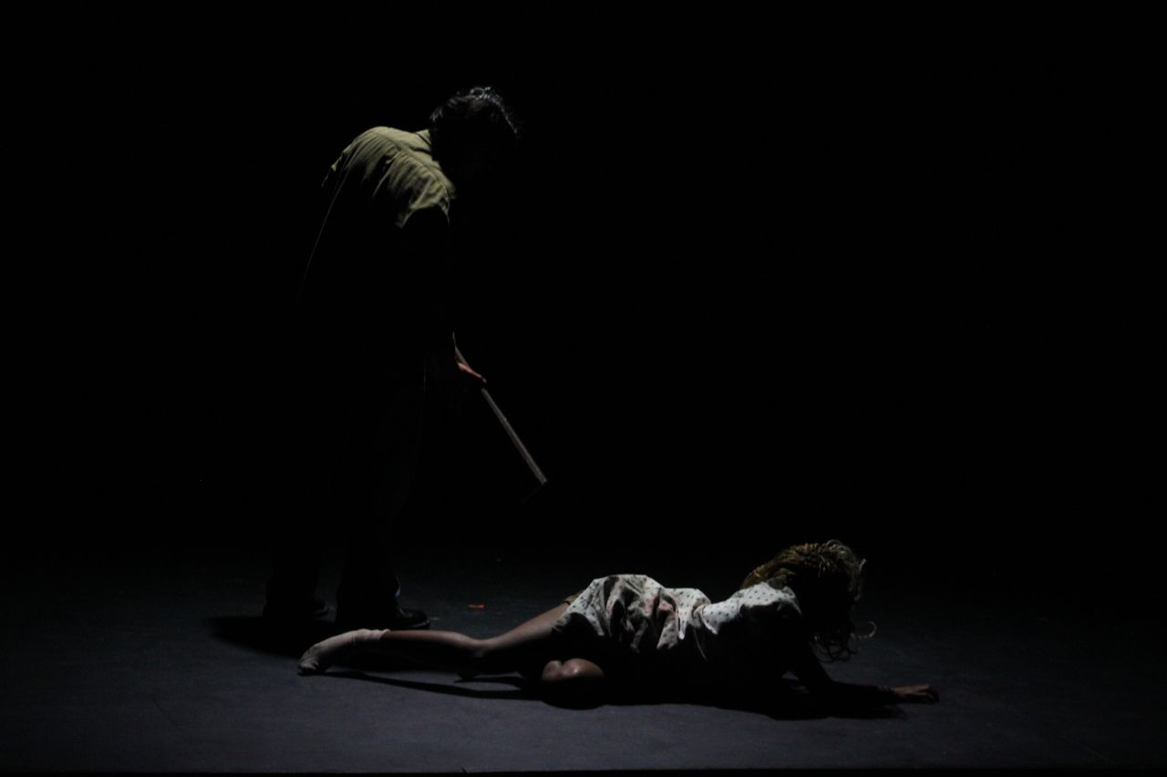 Darkened figure standing over Silent Hill nurse in Silent Hill 2 stage adaptation "Our Special Place"