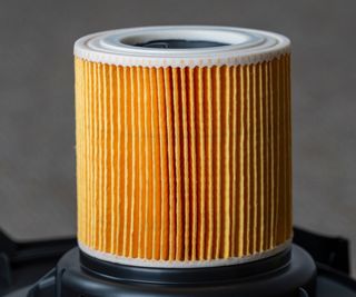 A yellow paper cartridge vacuum filter