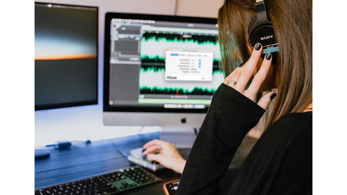 A woman listening to Dante-enabled audio through Sony headphones. 