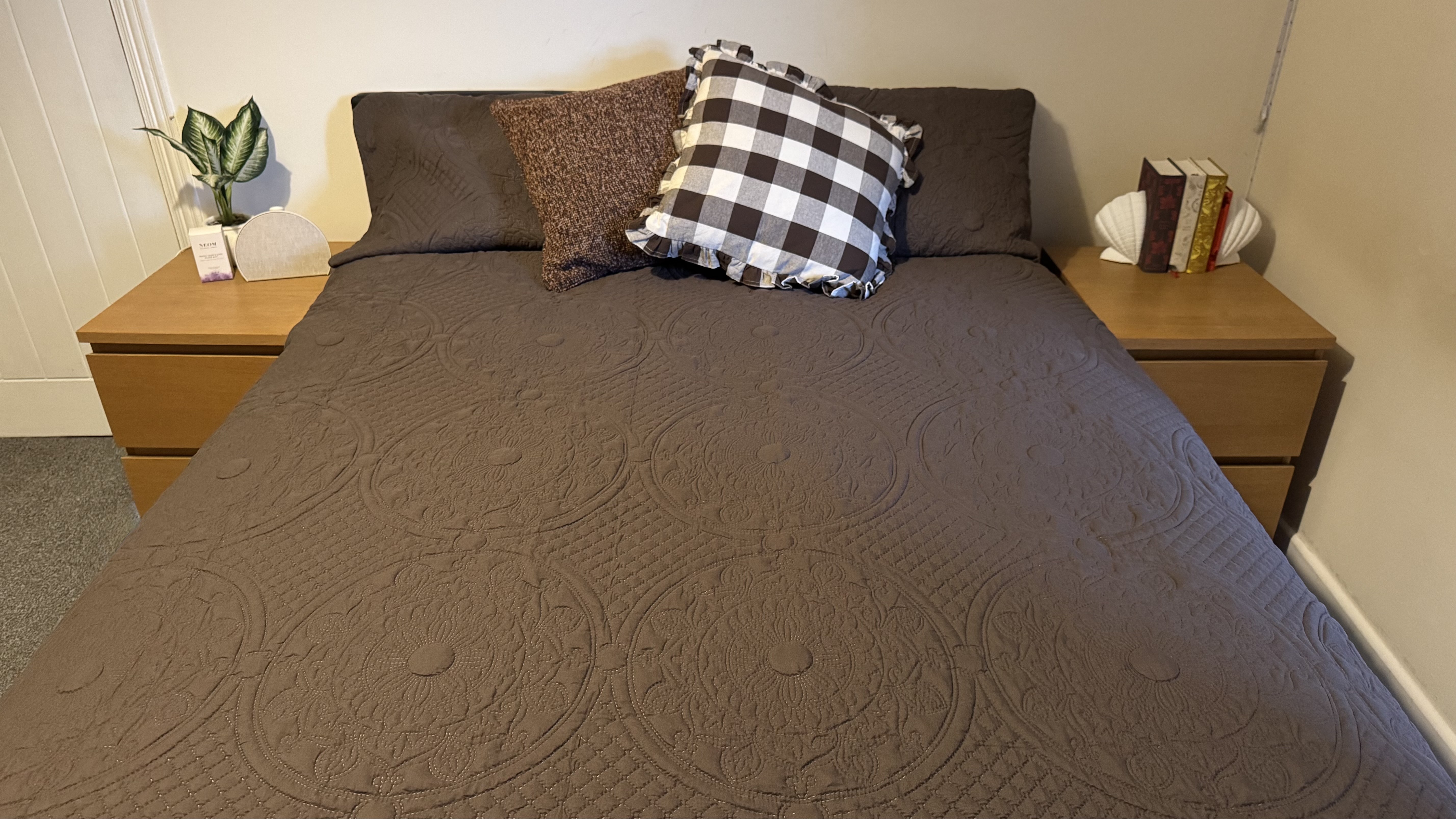 Bear Elite Hybrid Mattress on black bedframe in bedroom with two wooden bedside cabinets