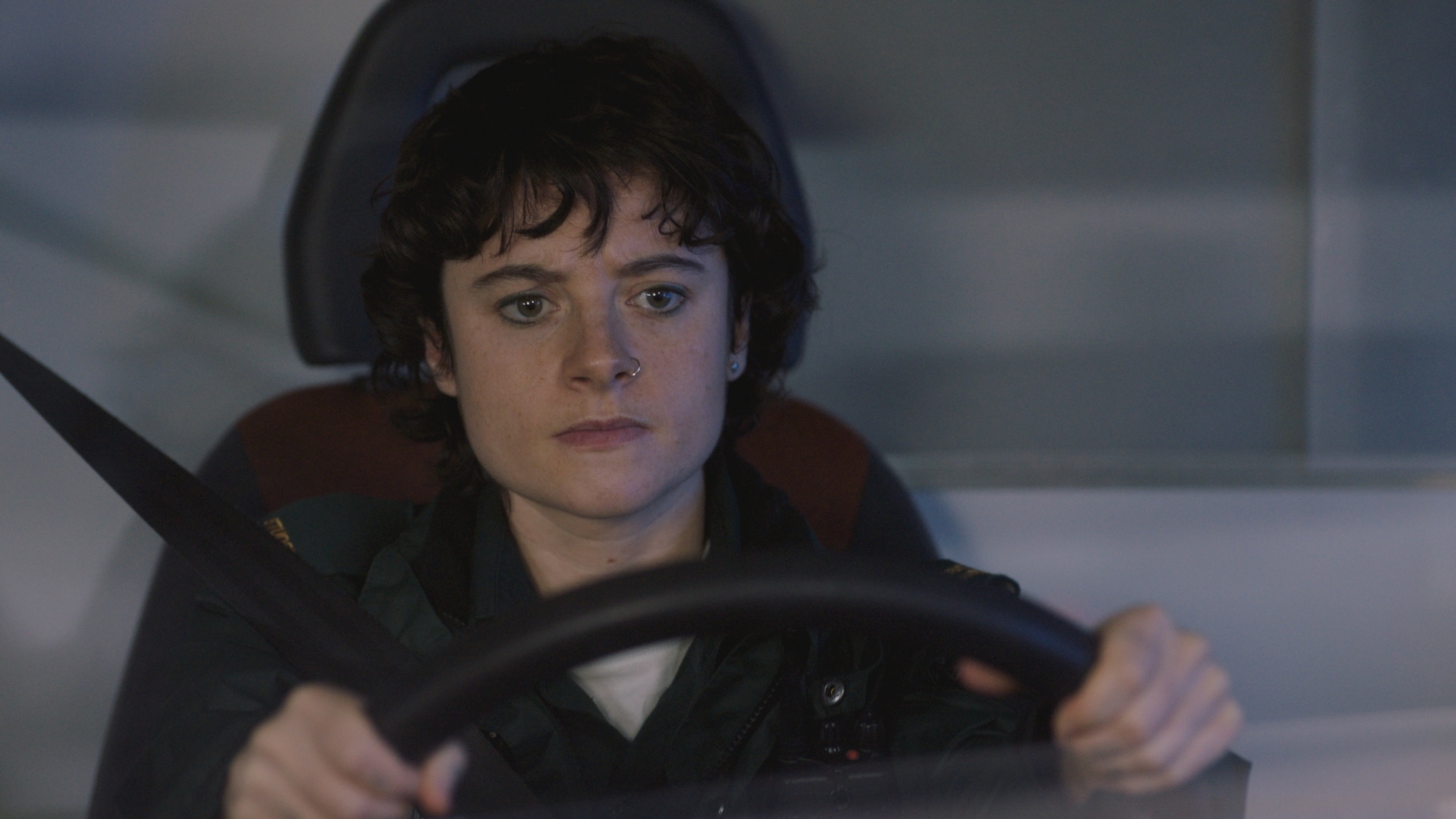 Indie in deep concentration while driving an ambulance.