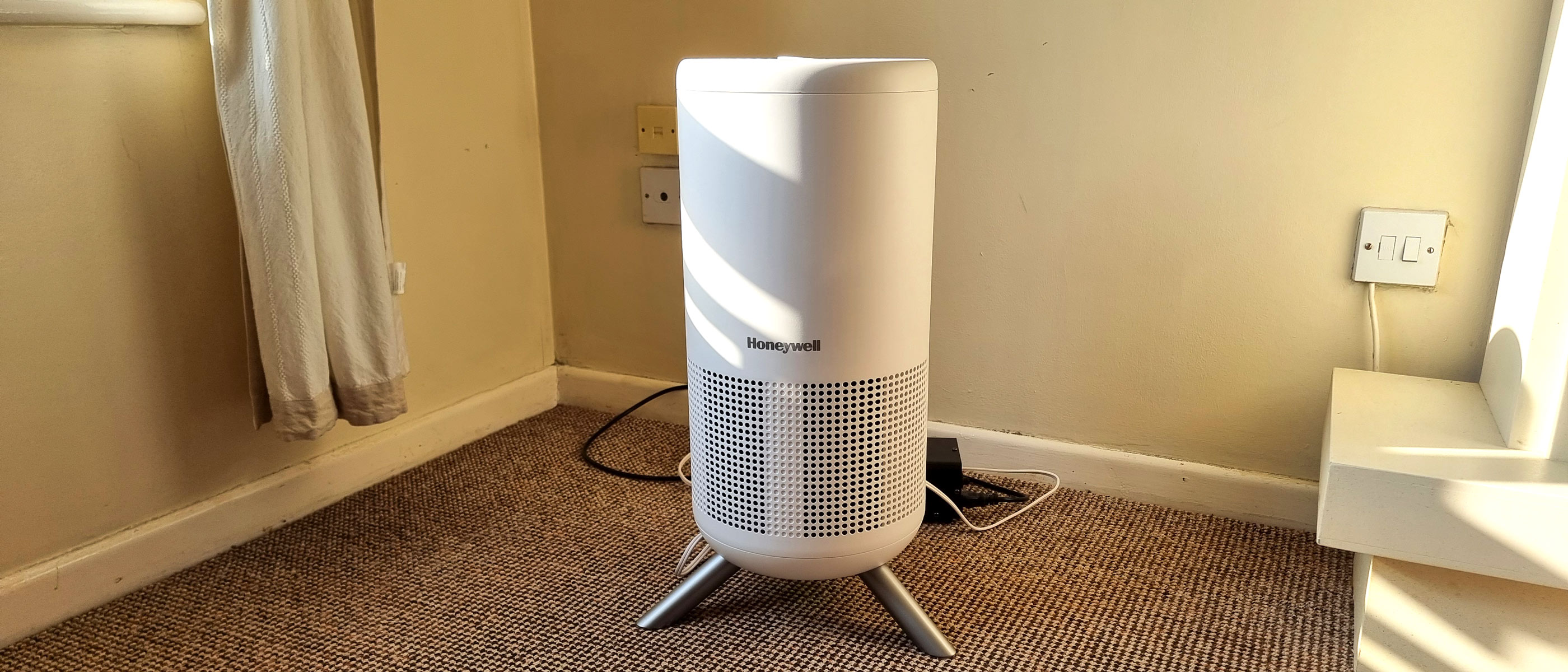 Honeywell Designer Series air purifier standing in a corner of a sunlit room
